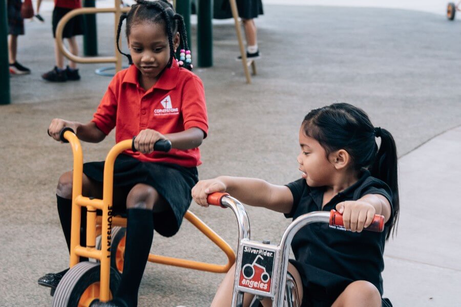 young girls playing on bikes