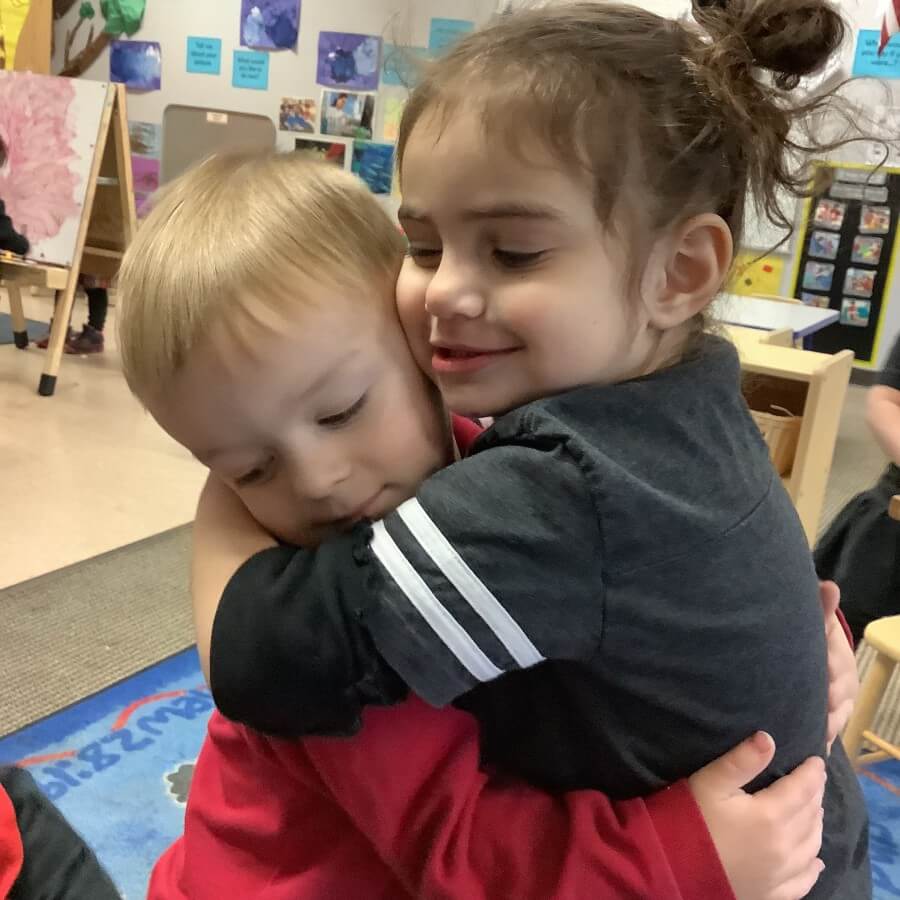 kids hugging at school